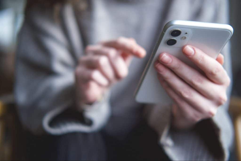 Close-up of a person's hands holding and using a smartphone