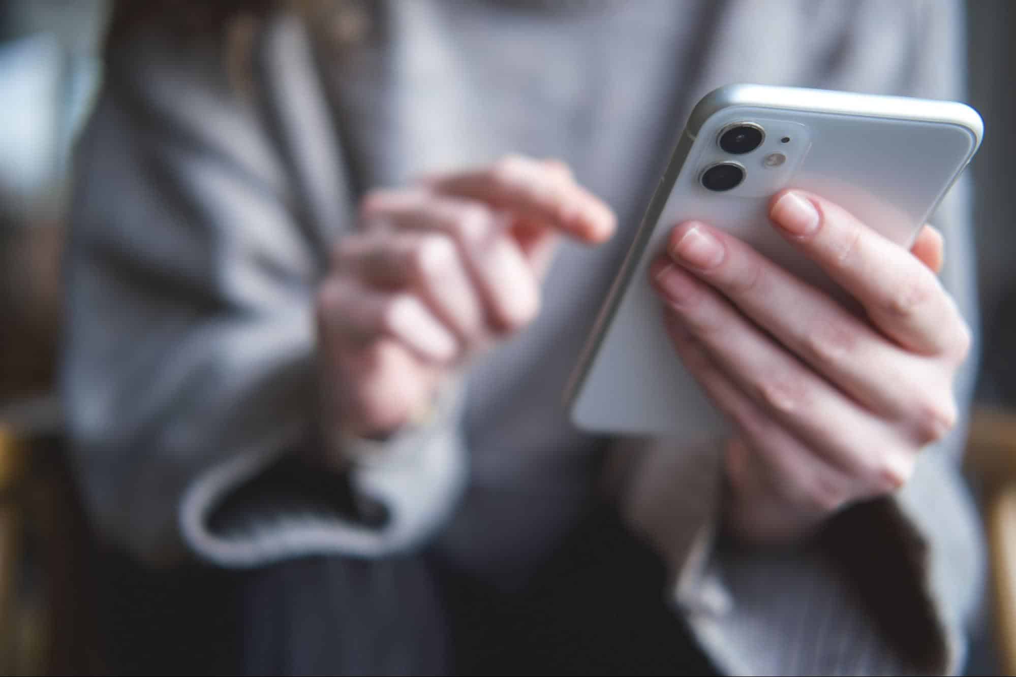 Close-up of a person's hands holding and using a smartphone