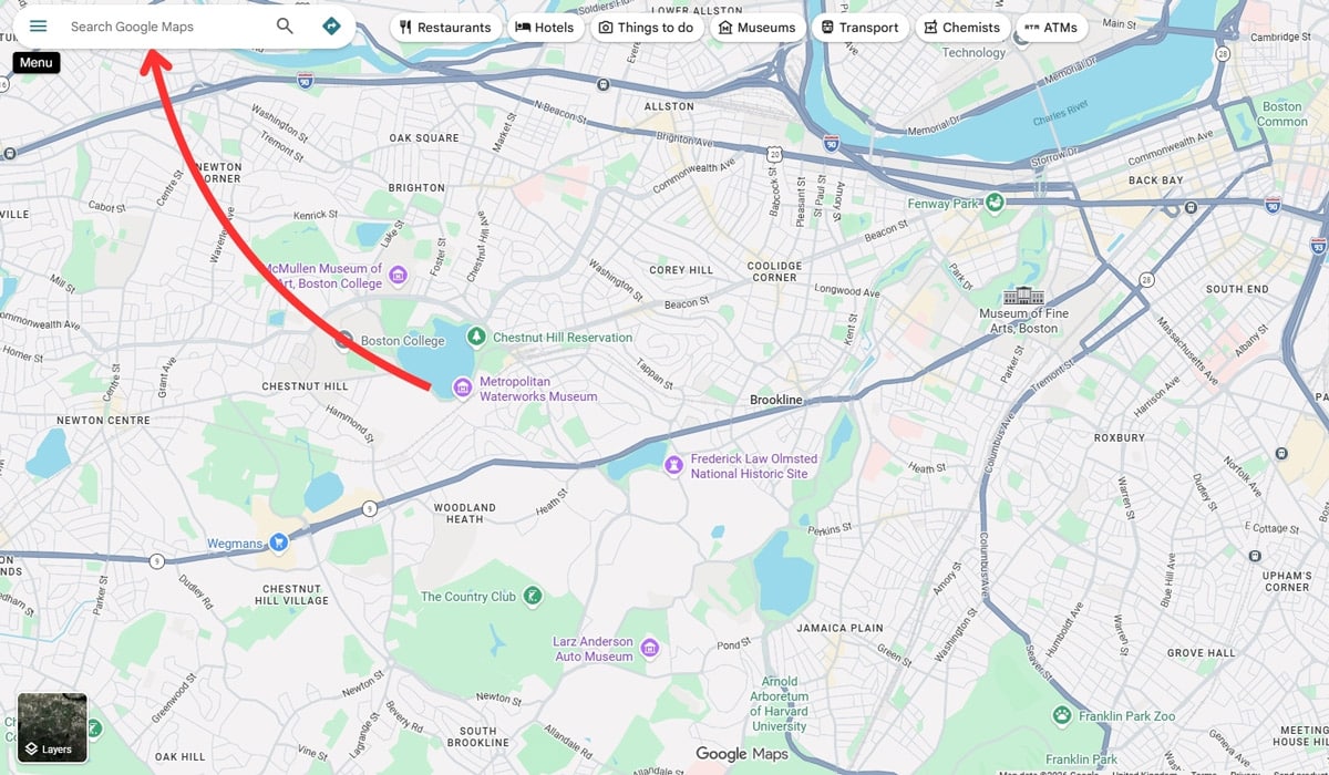 Google Maps interface with an arrow pointing to the search bar for entering an address